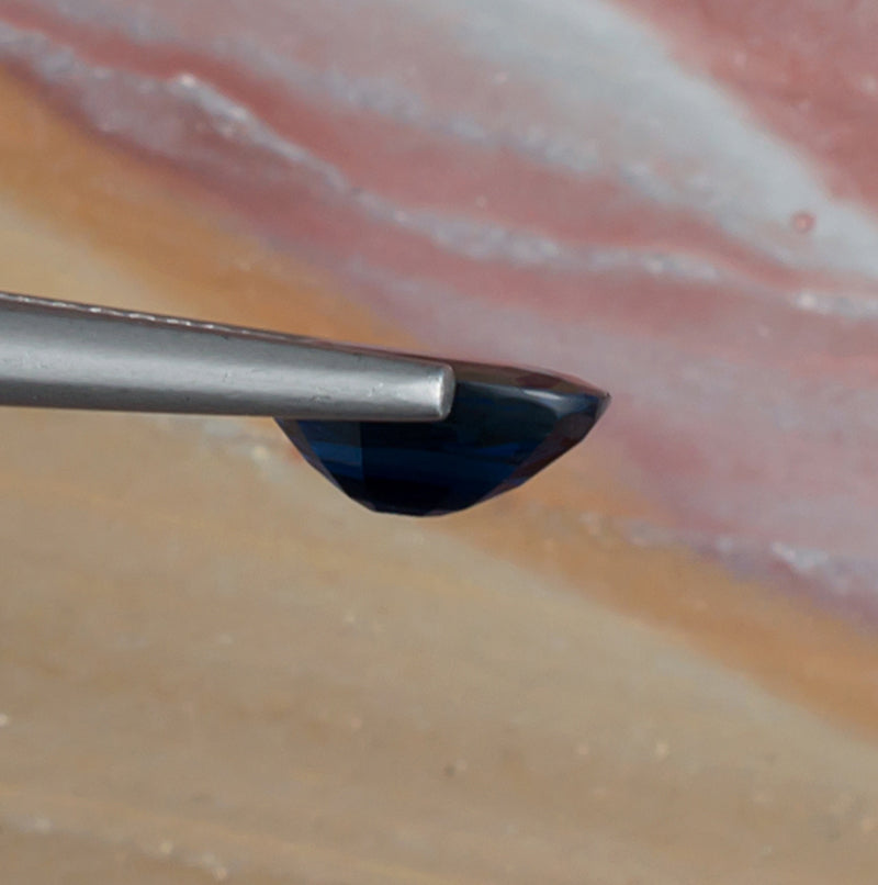 1.61ct Blue Sapphire Colored Gemstone Side View Natural Background