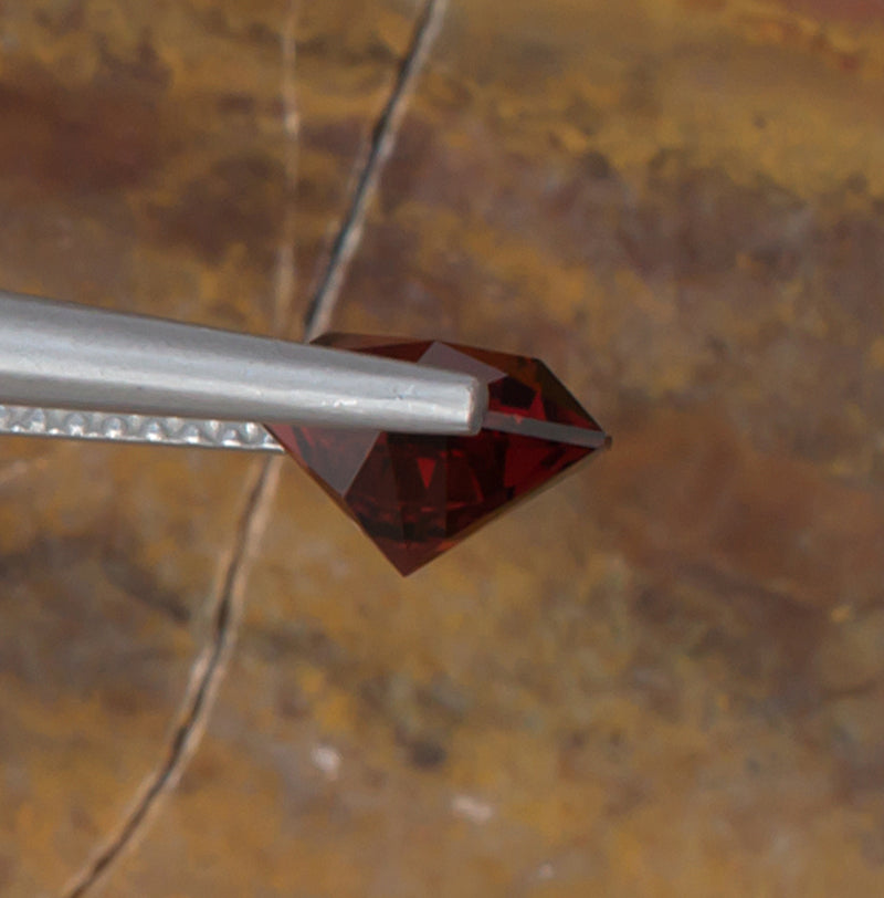 1.92ct Malaya Garnet Colored Gemstone Side View Natural Background