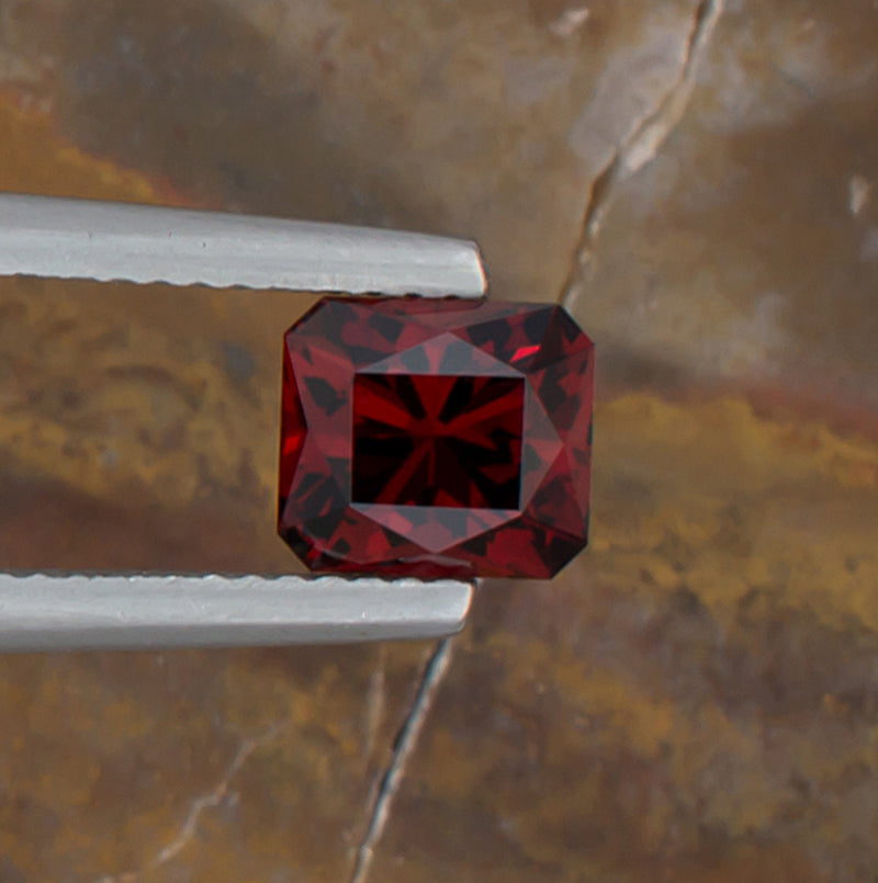 1.92ct Malaya Garnet Colored Gemstone Top View Natural Background