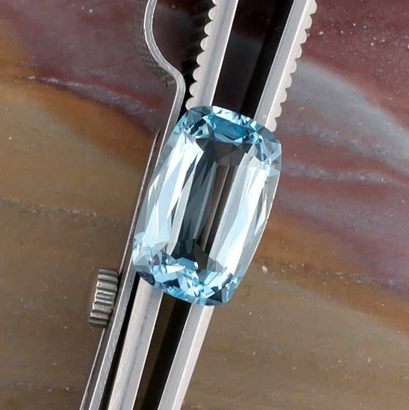 3.07ct Aquamarine Colored Gemstone Top View Tweezers Natural Background