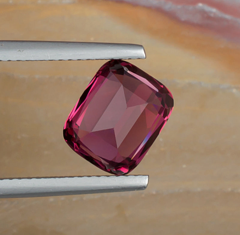 3.94ct Rhodolite Garnet Colored Gemstone Bottom View Natural Background