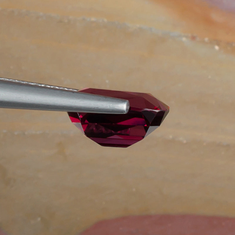 3.94ct Rhodolite Garnet Colored Gemstone Side View Natural Background
