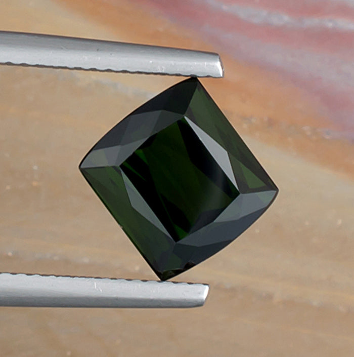 3.99ct Green Tourmaline Colored Gemstone Top View Angle Natural Background
