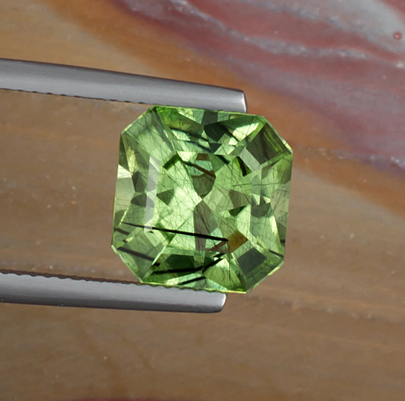 4.99ct Peridot Colored Gemstone with Rutile Inclusions Top View II Natural Background