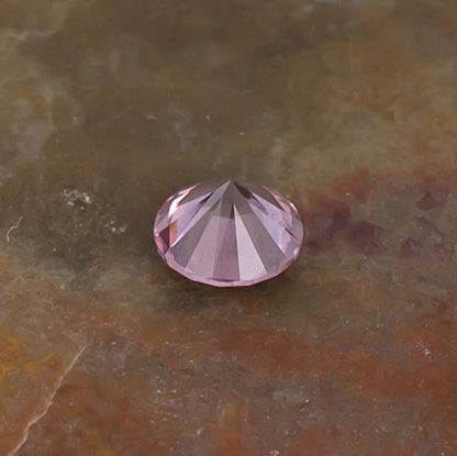 0.41ct Malaya Garnet Colored Gemstone Side Front Natural Background
