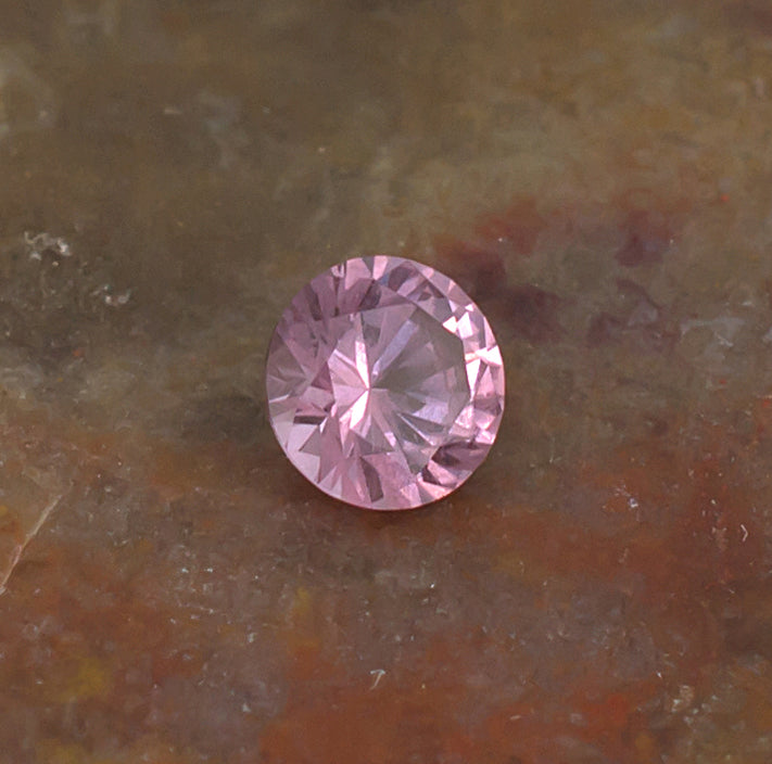 0.41ct Malaya Garnet Colored Gemstone Side Front Natural Background
