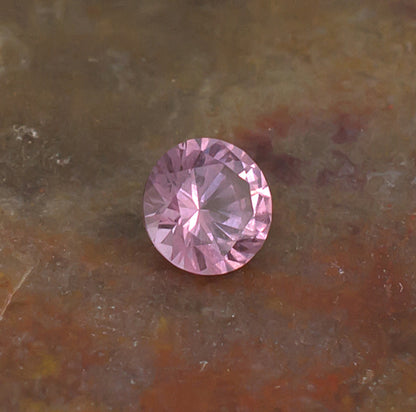 0.41ct Malaya Garnet Colored Gemstone Side Front Natural Background

