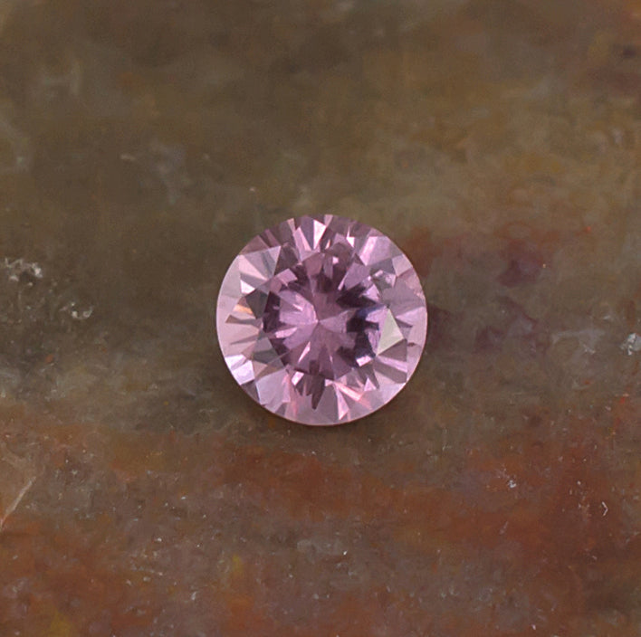 0.41ct Malaya Garnet Colored Gemstone Side Front Natural Background
