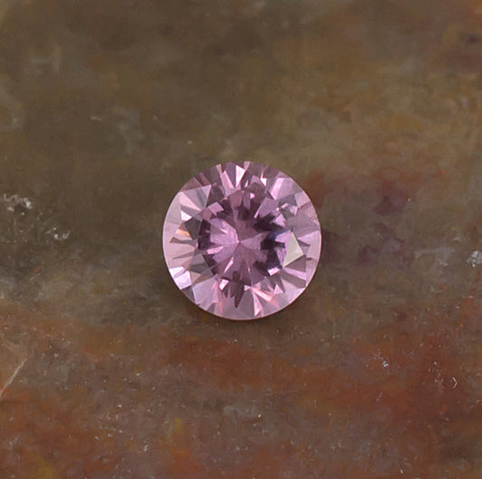 0.41ct Malaya Garnet Colored Gemstone Side Front Natural Background
