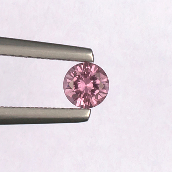 0.41ct Malaya Garnet Colored Gemstone Top View White Background
