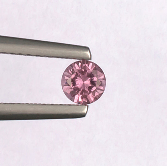 0.41ct Malaya Garnet Colored Gemstone Top View White Background
