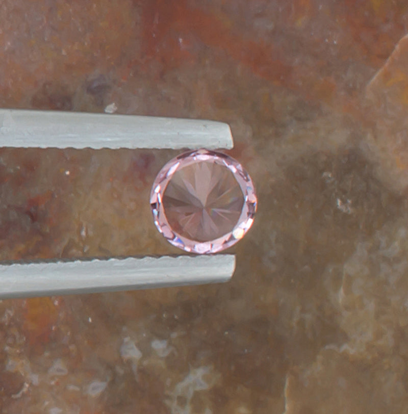 0.59ct Malaya Garnet Colored Gemstone Bottom View Natural Background 
