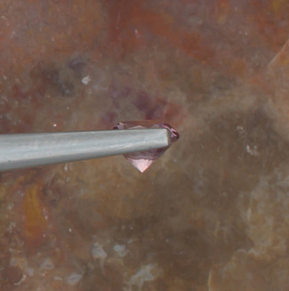 0.59ct Malaya Garnet Colored Gemstone Side View Natural Background 
