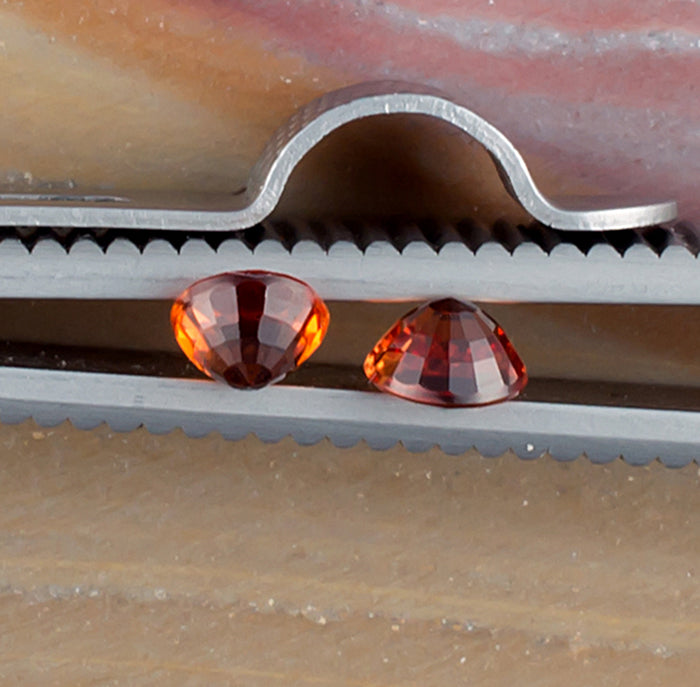 0.93twt Orange Sapphire Colored Gemstone Pair Side View Natural Background 
