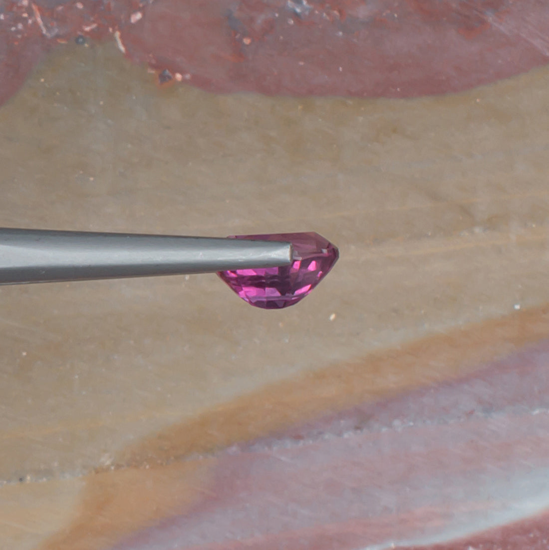 1.11ct Malaya Garnet Colored Gemstone Side View Natural Background 
