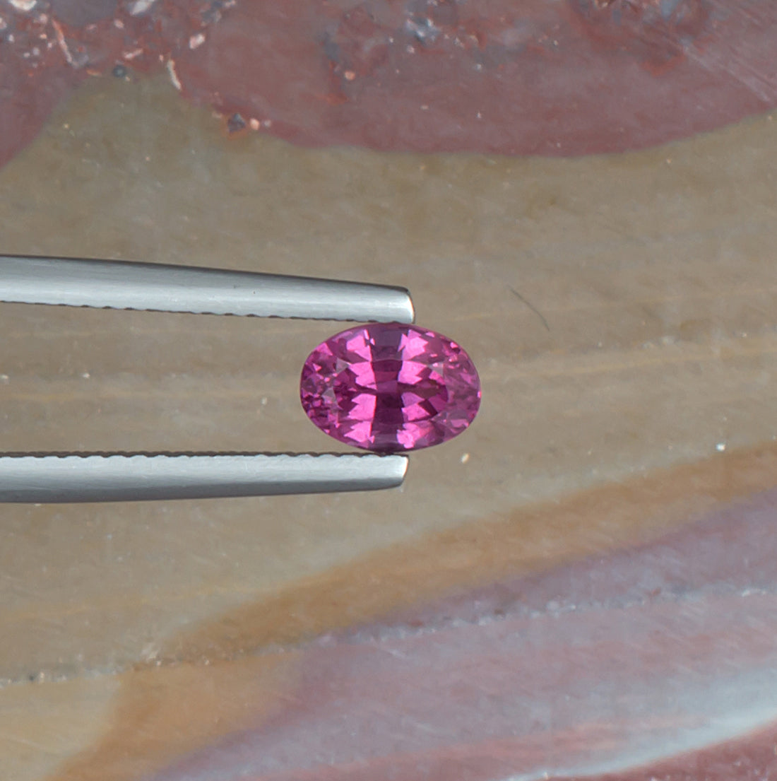 1.11ct Malaya Garnet Colored Gemstone Top View II Natural Background 

