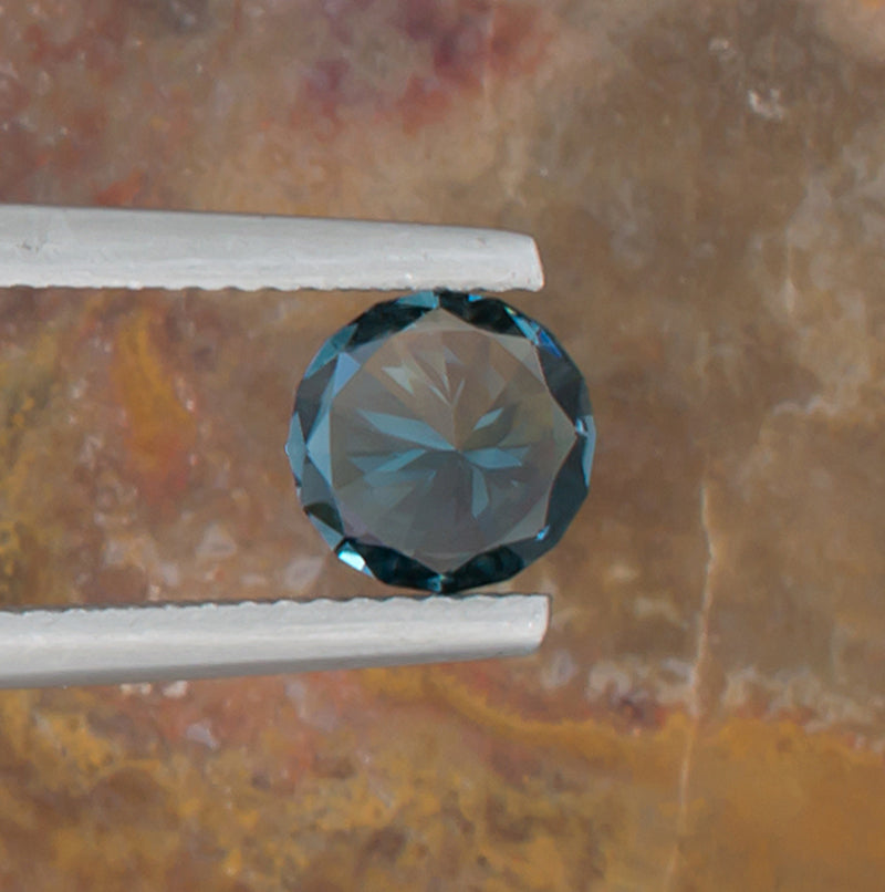 1.24ct Blue Topaz Colored Gemstone Bottom View Natural Background 
