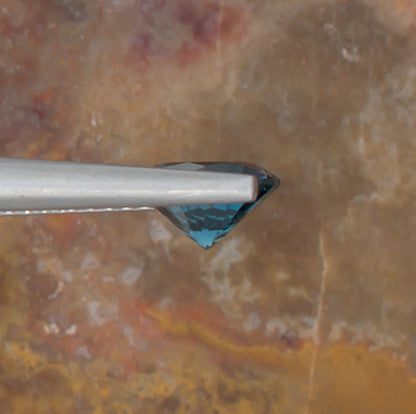 1.24ct Blue Topaz Colored Gemstone Side View Natural Background 
