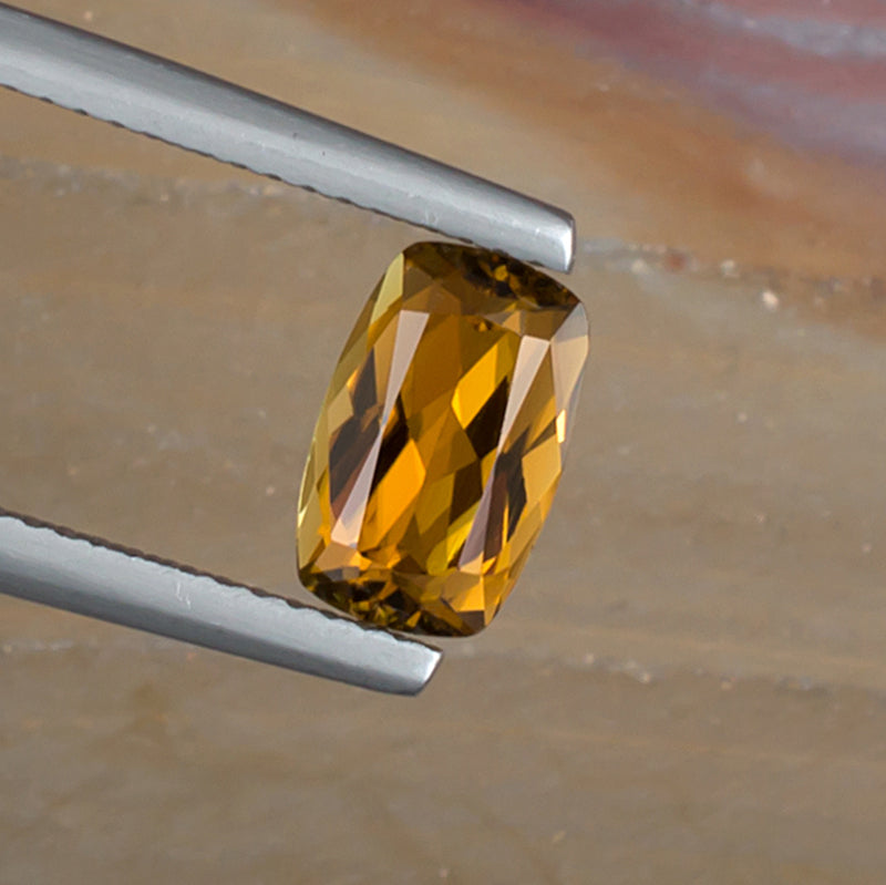1.52ct Golden Tourmaline Colored Gemstone Top View Angle Natural Background 
