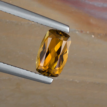 1.52ct Golden Tourmaline Colored Gemstone Top View Angle Natural Background 
