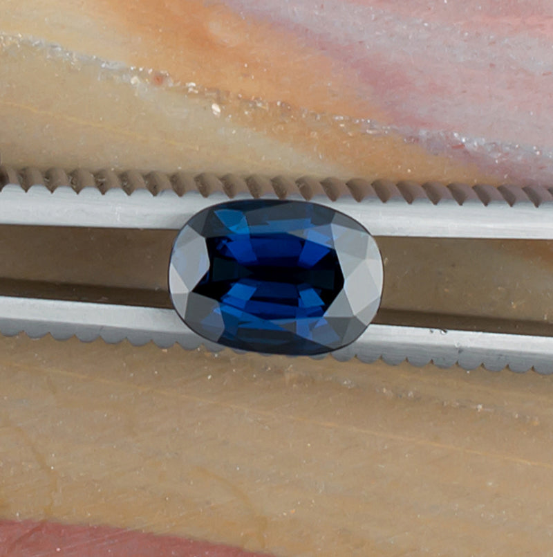 1.61ct Blue Sapphire Colored Gemstone Top View Natural Background 
