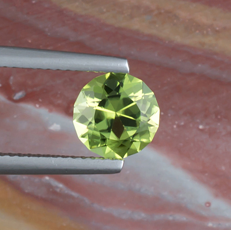 1.64ct Peridot Colored Gemstone Top View Natural Background 
