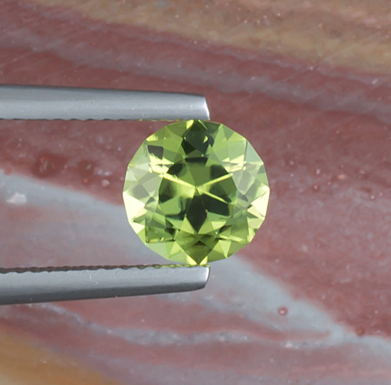 1.64ct Peridot Colored Gemstone Top View Natural Background 
