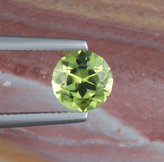 1.64ct Peridot Colored Gemstone Top View Natural Background 
