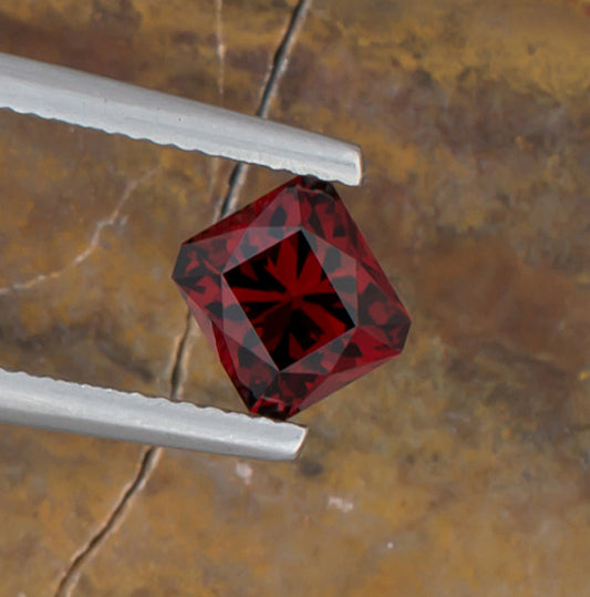 1.92ct Malaya Garnet Colored Gemstone Top View Angle Natural Background 

