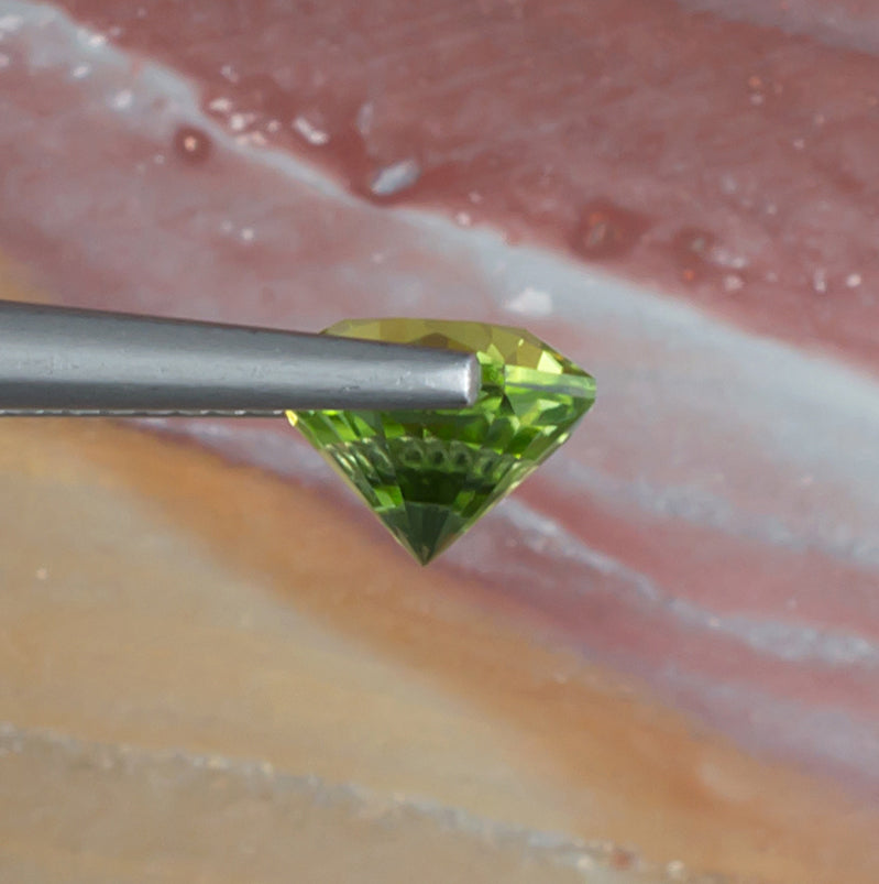 1.92ct Peridot Colored Gemstone Side View Natural Background
