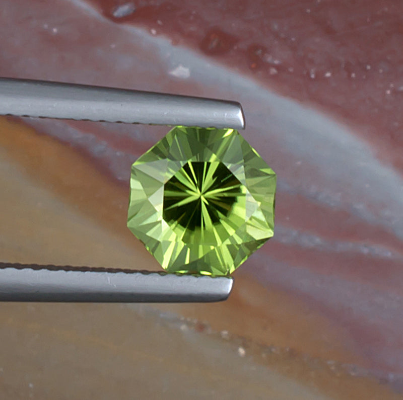 1.92ct Peridot Colored Gemstone Top View Natural Background 
