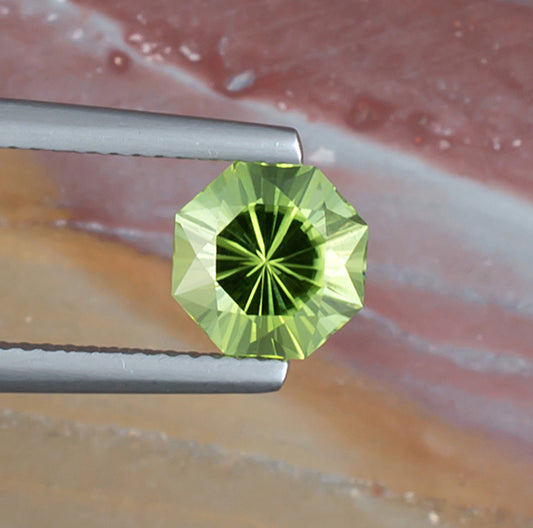 1.92ct Peridot Colored Gemstone Top View Natural Background 
