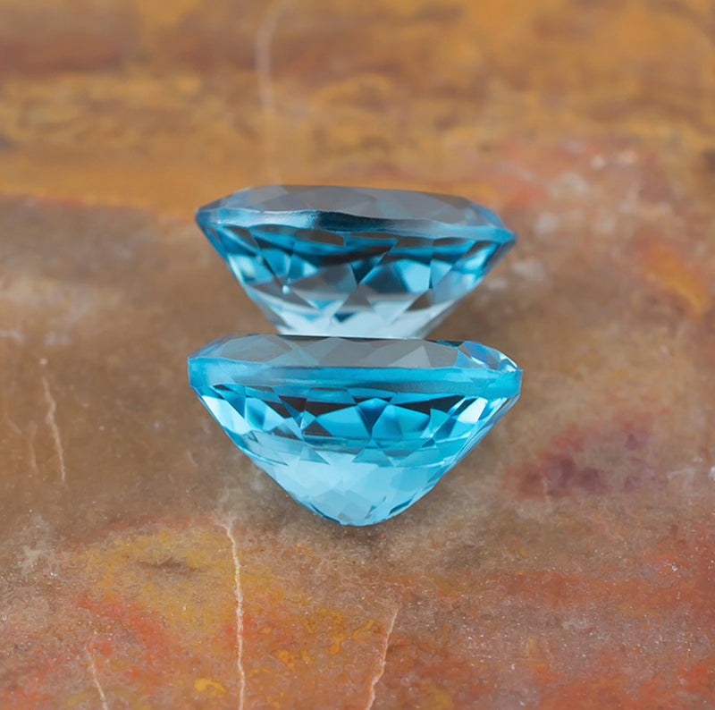 11.87twt Blue Topaz Colored Gemstone Pair Back View Natural Background
