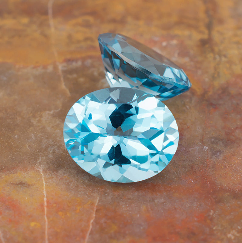 11.87twt Blue Topaz Colored Gemstone Pair Top Back View Natural Background 
