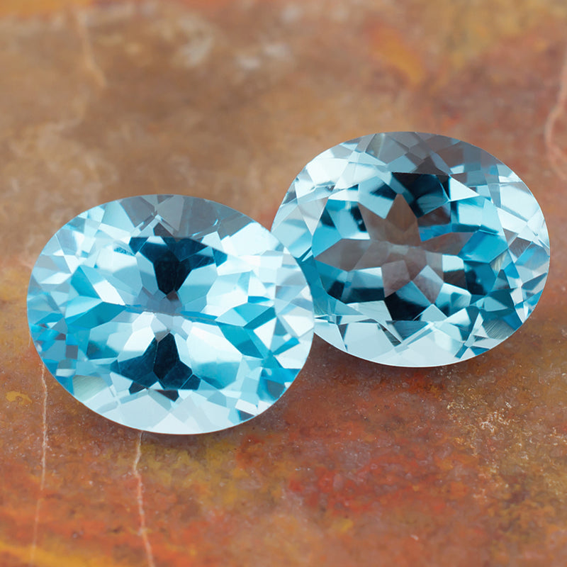 11.87twt Blue Topaz Colored Gemstone Pair Top View Natural Background 
