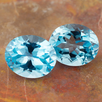 11.87twt Blue Topaz Colored Gemstone Pair Top View Natural Background 
