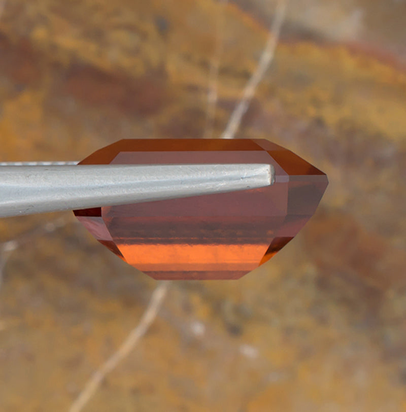 12.02ct Hessonite Garnet Colored Gemstone Side View Natural Background