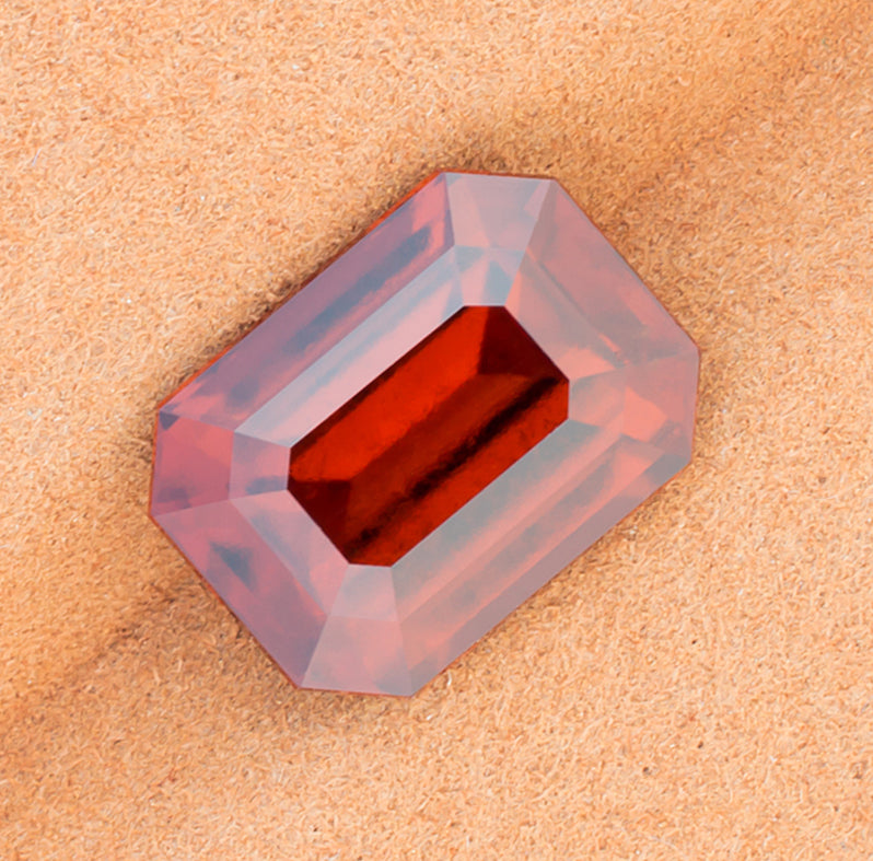 12.02ct Hessonite Garnet Colored Gemstone Top View Brown Background