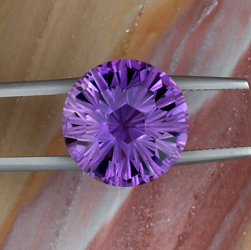 12.20ct Amethyst Colored Gemstone Top View Tweezers Natural Background
