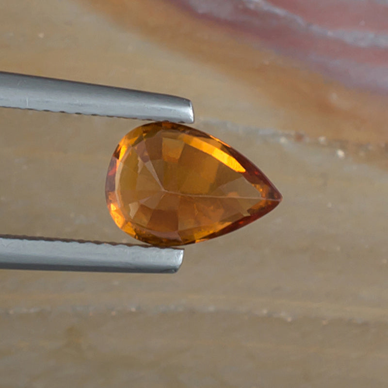 2.06ct Hessonite Garnet Colored Gemstone Bottom View Natural Background 
