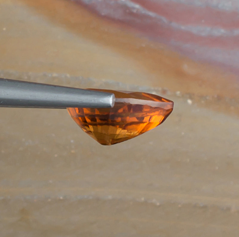2.06ct Hessonite Garnet Colored Gemstone Side View Natural Background 
