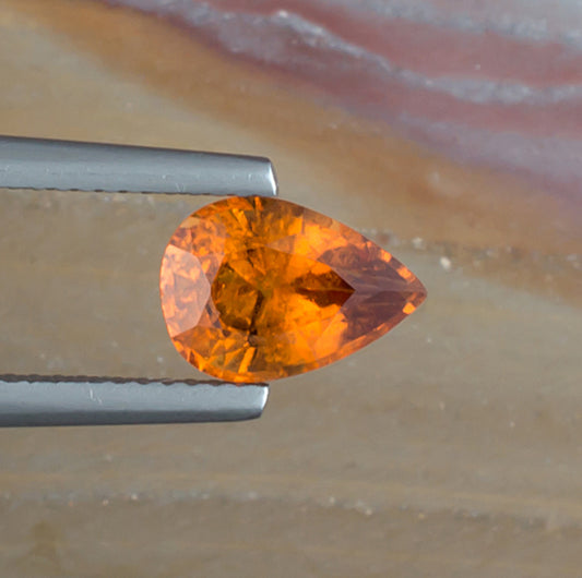 2.06ct Hessonite Garnet Colored Gemstone Top View II Natural Background
