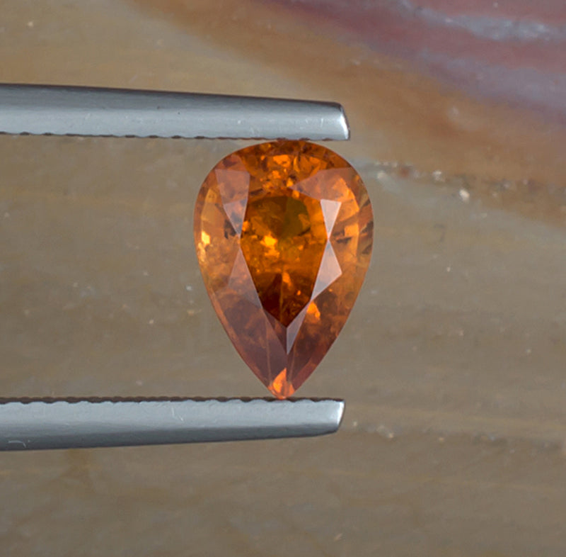 2.06ct Hessonite Garnet Colored Gemstone Top View Natural Background
