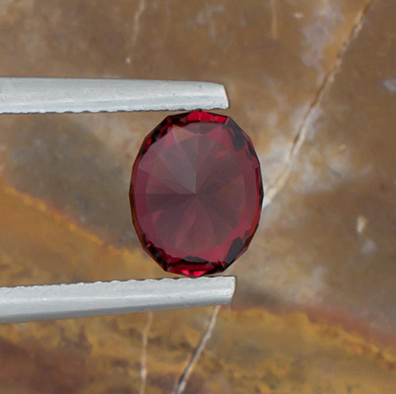 2.07ct Malaya Garnet Colored Gemstone Bottom View Natural Background