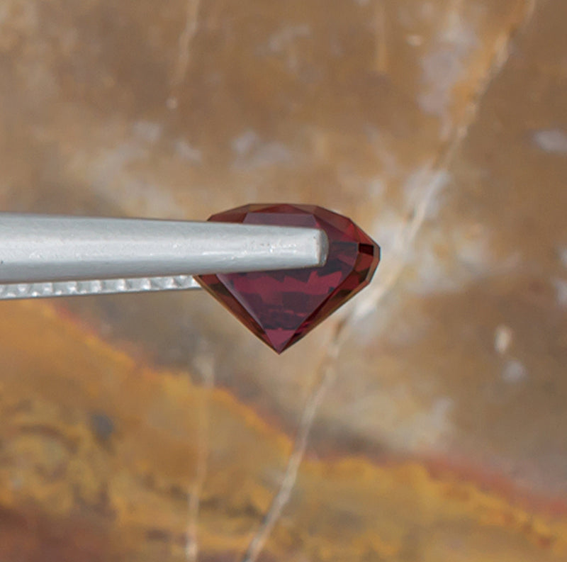 2.07ct Malaya Garnet Colored Gemstone Side View Natural Background 