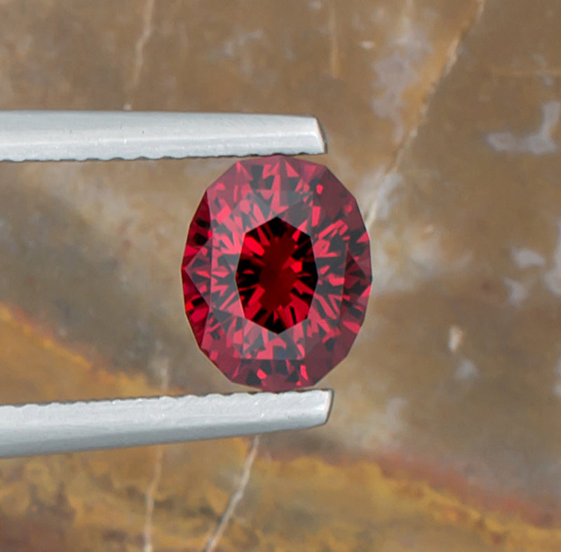 2.07ct Malaya Garnet Colored Gemstone Top View II Natural Background 