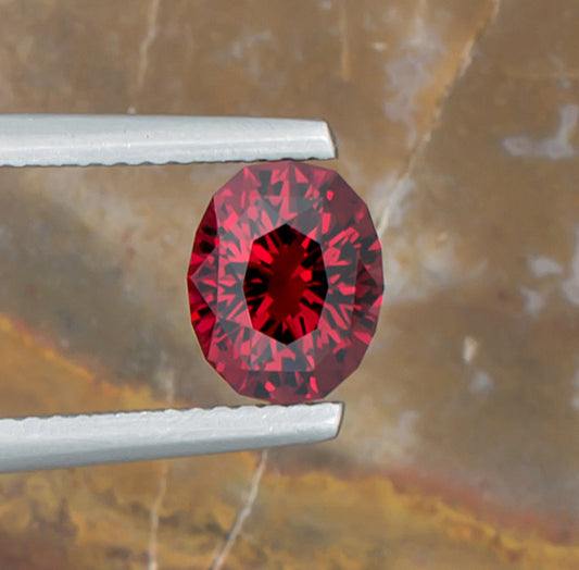 2.07ct Malaya Garnet Colored Gemstone Top View II Natural Background 