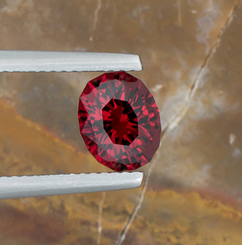 2.07ct Malaya Garnet Colored Gemstone Top View Natural Background 