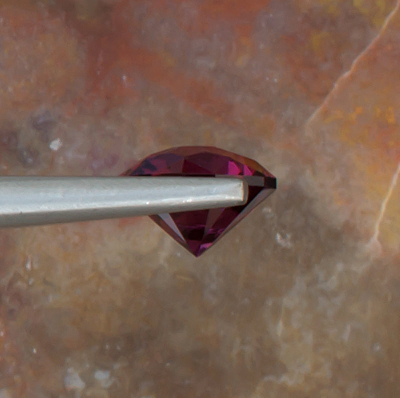 2.21ct Umbalite Garnet Colored Gemstone Side View Natural Background 
