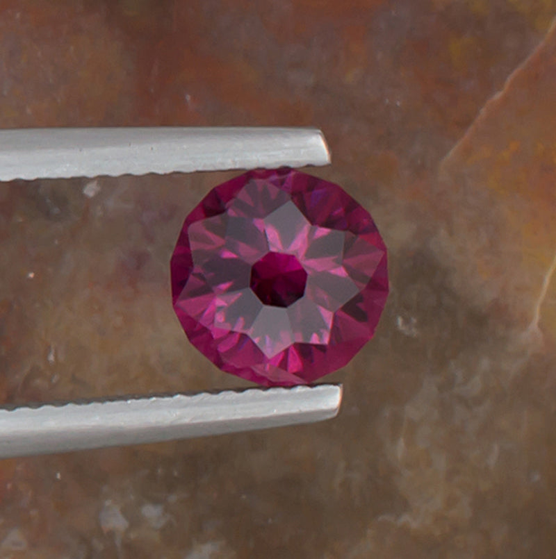 2.21ct Umbalite Garnet Colored Gemstone Top View Natural Background 
